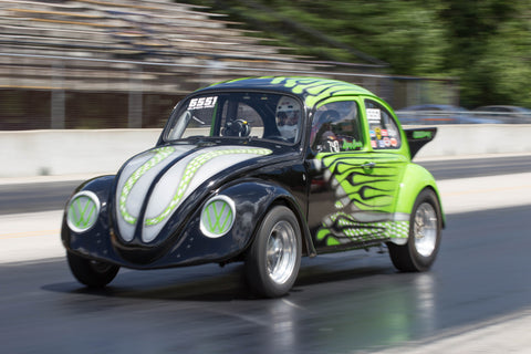 VW Beetle racing down the drag strip track