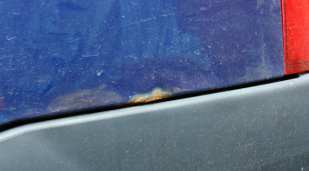 surface rust on a blue car