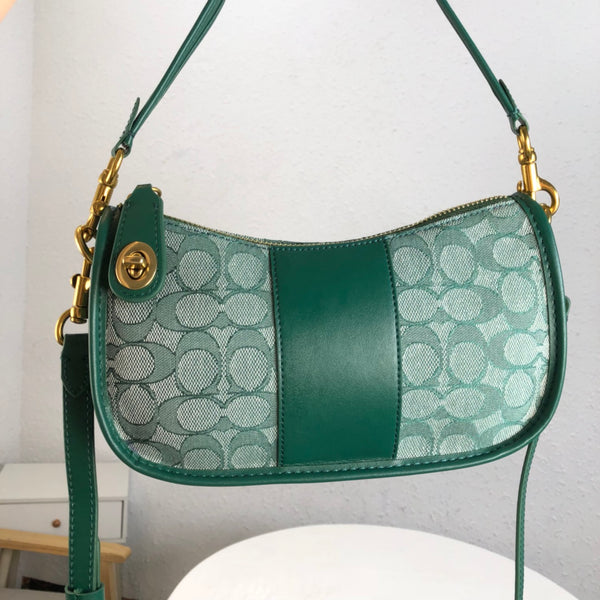 coach swinger bag in signature jacquard green