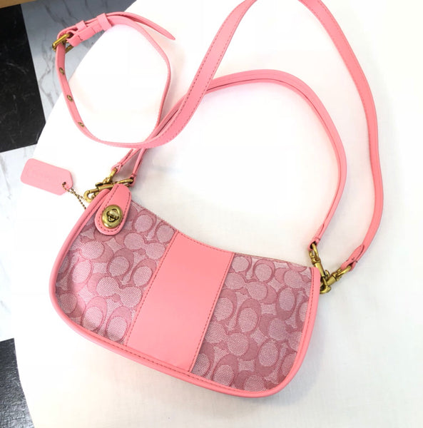 coach swinger bag in signature jacquard pink