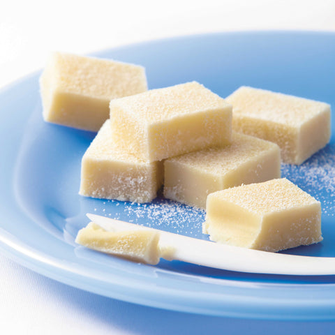 Image shows white chocolate blocks on blue plate.