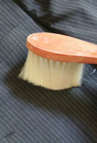 cleaning custom suit with brush