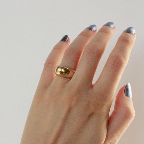 solid bulbous statement gold ring on hand