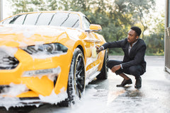 Guy Washing Car in Suit