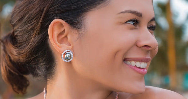 Woman wearing Earrings with Tahitian Black Pearls and Diamonds