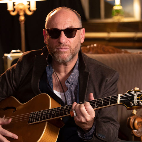 David Sereny with guitar and sunglasses