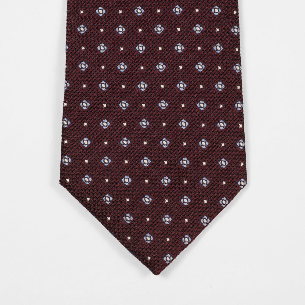 Burgundy woven silk tie, light blue and white neat motifs