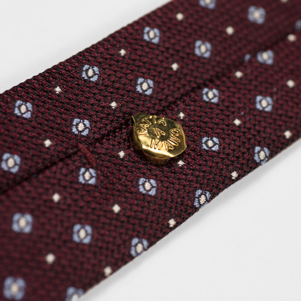 Burgundy woven silk tie, light blue and white neat motifs