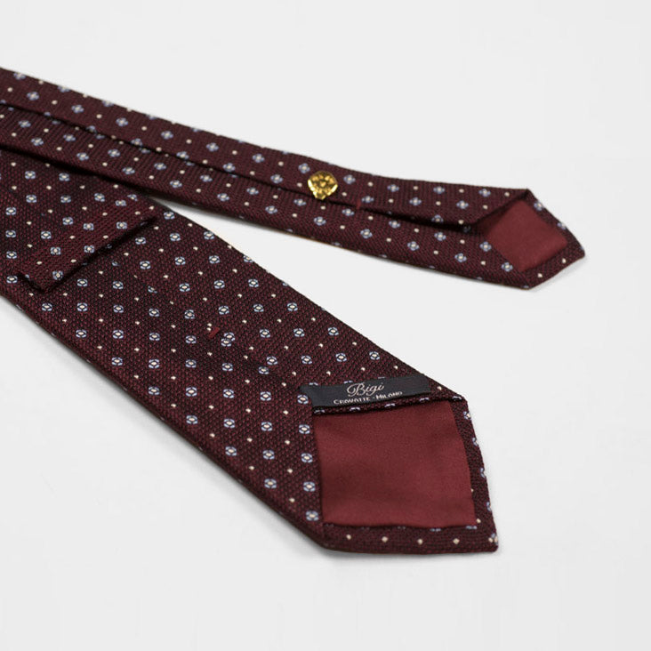 Burgundy woven silk tie, light blue and white neat motifs