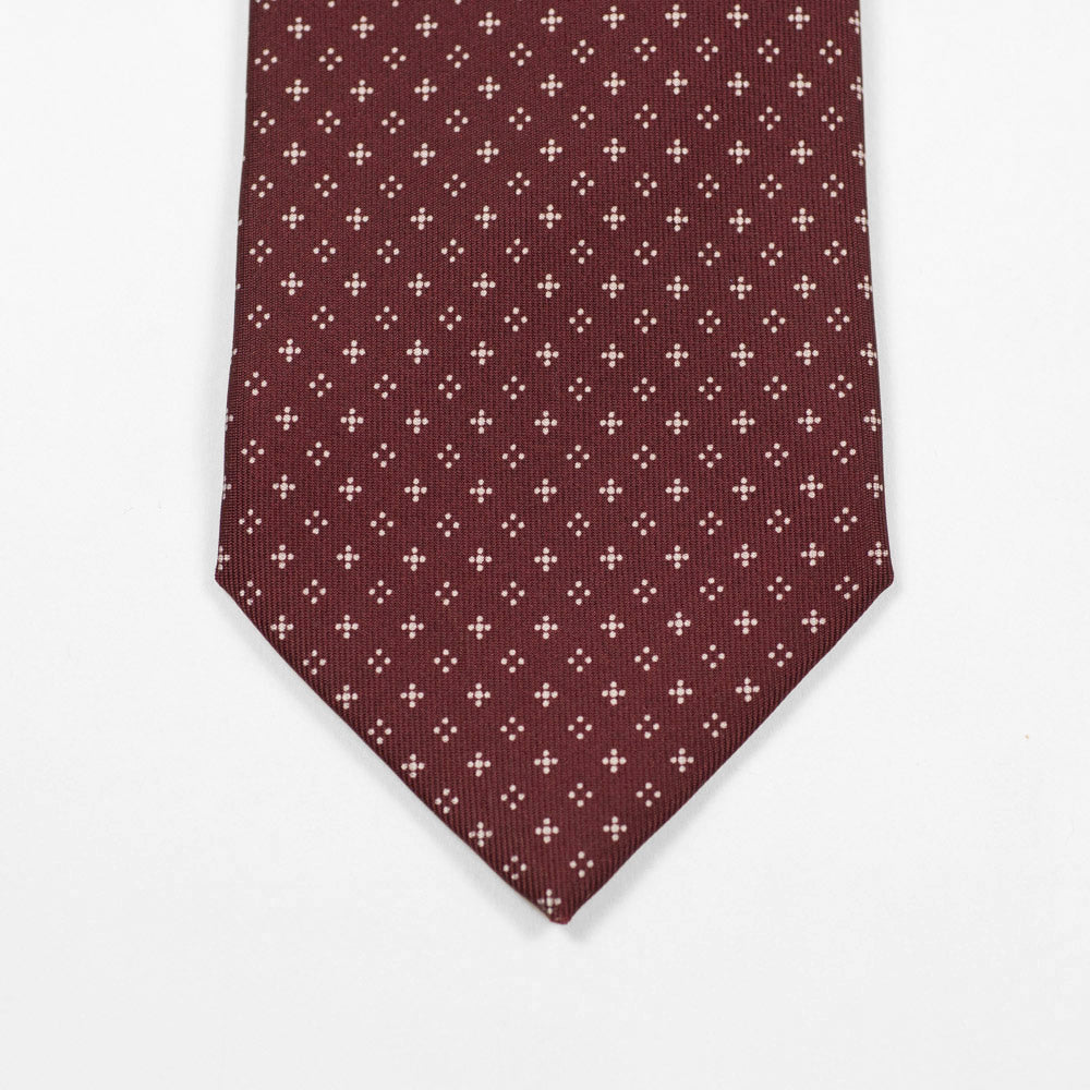 Burgundy silk tie, white hand-printed neat motifs, self-tipped