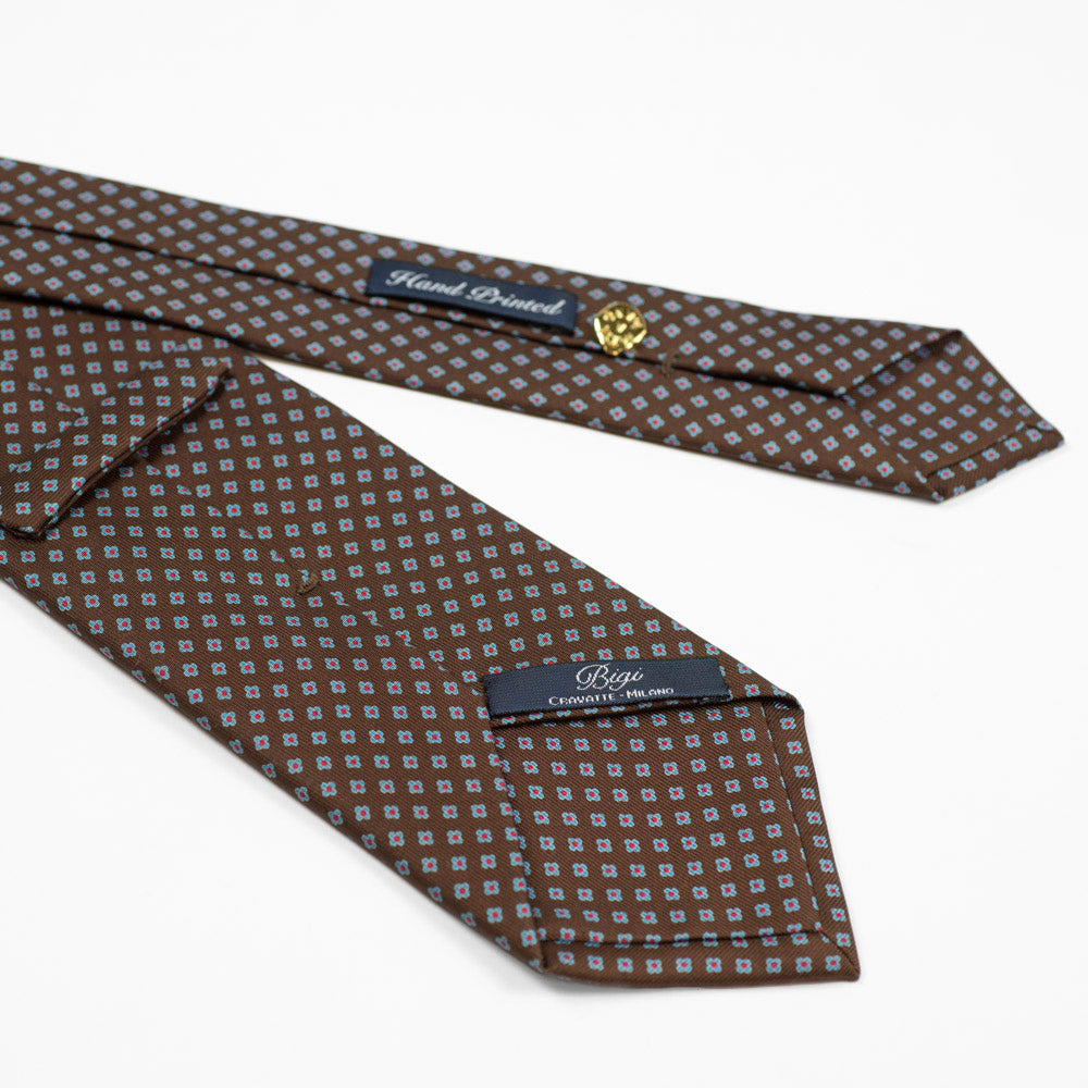 Brown silk tie, blue and cranberry hand-printed neat motifs, self-tipped