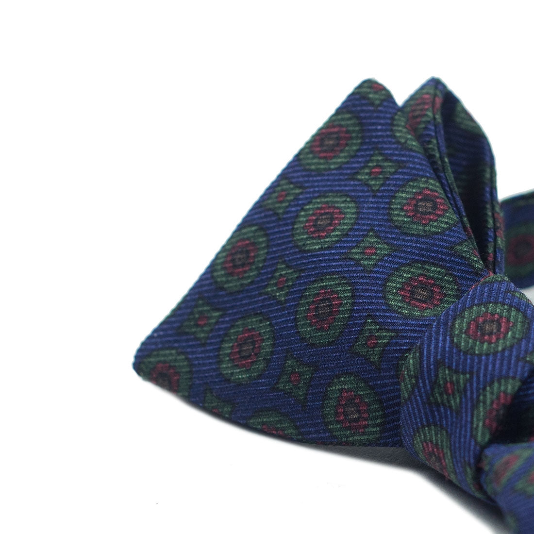 Blue silk bow tie with green & rust neat print