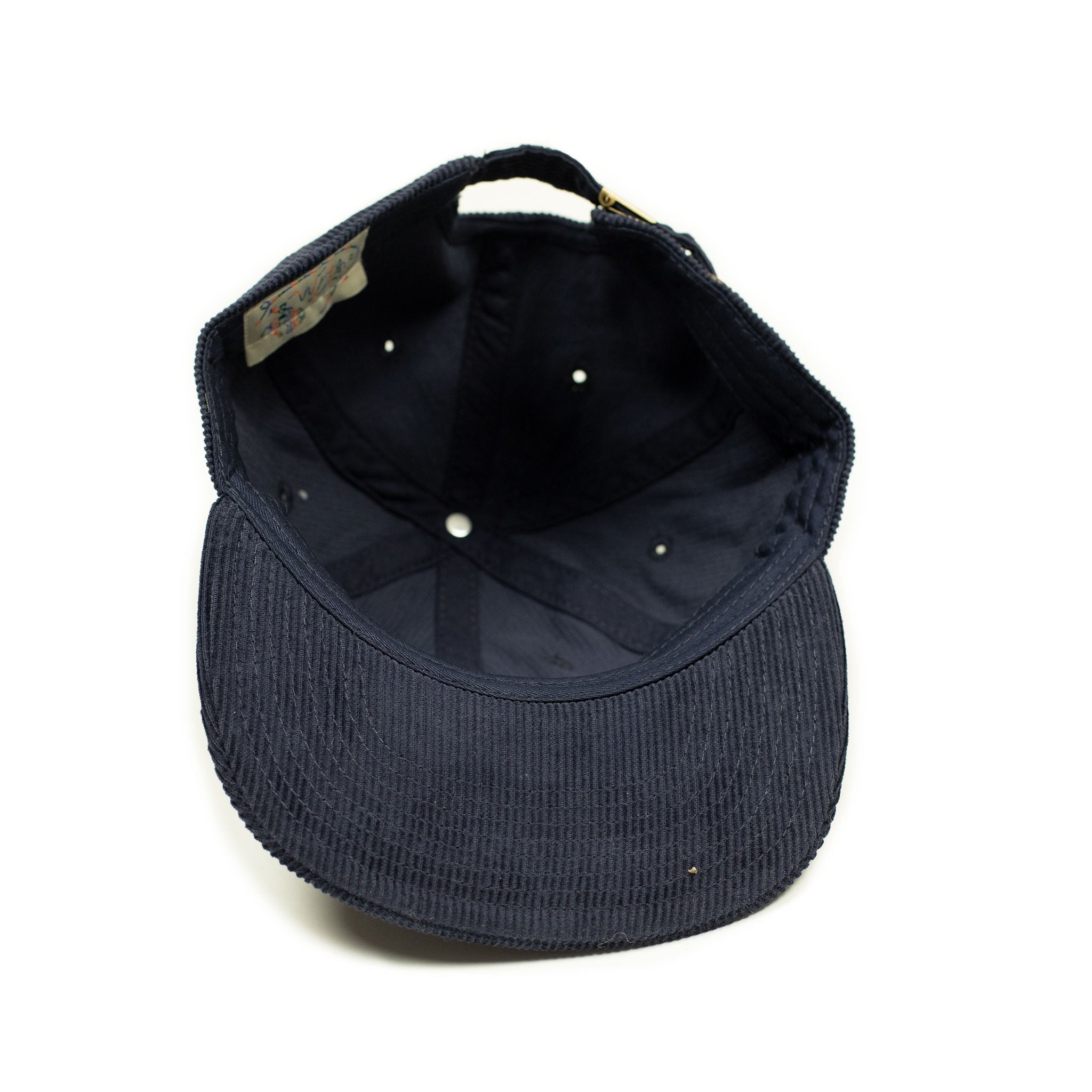 Corduroy cap in navy with racing flag chainstitched embroidery