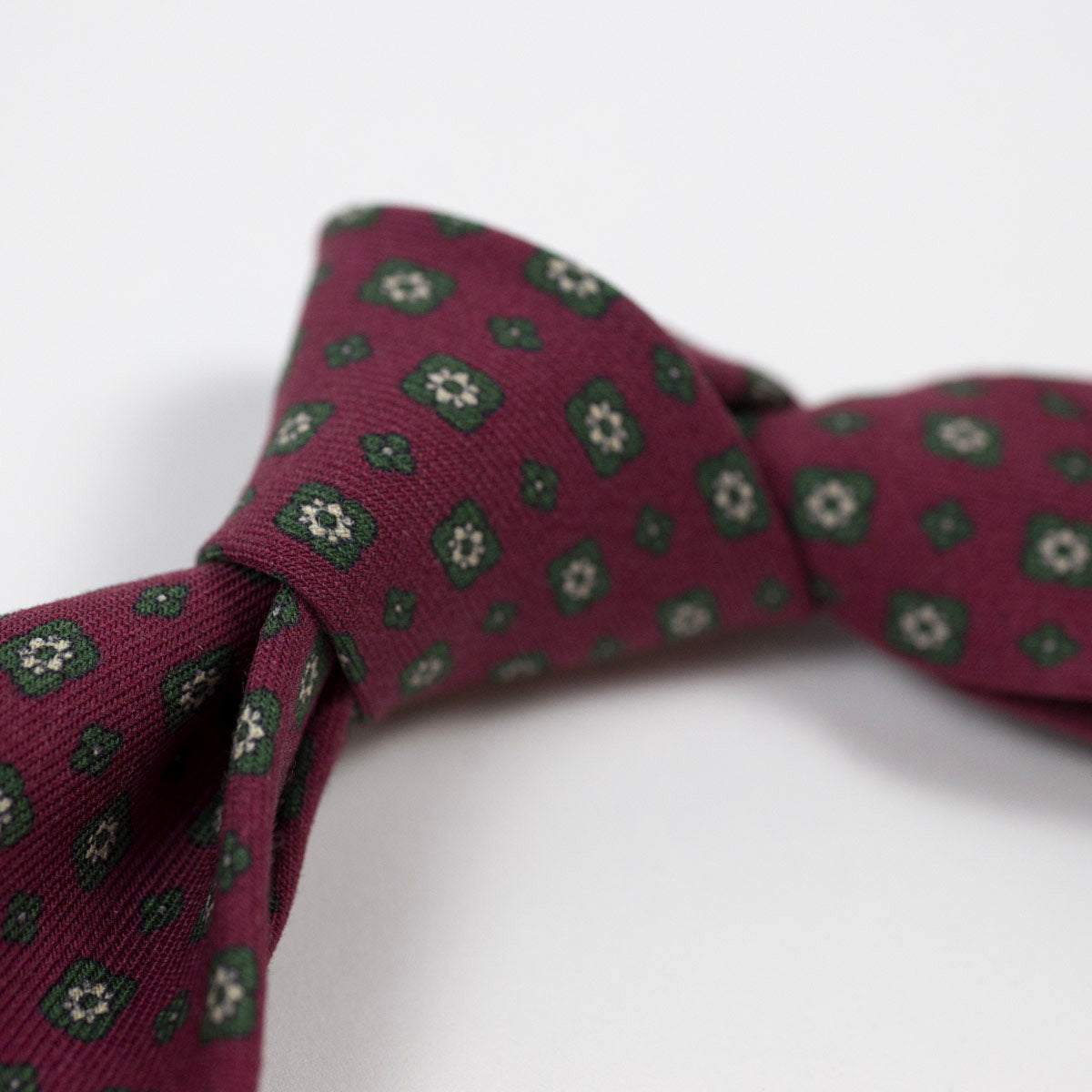 Burgundy self-tipped wool tie, green neat print