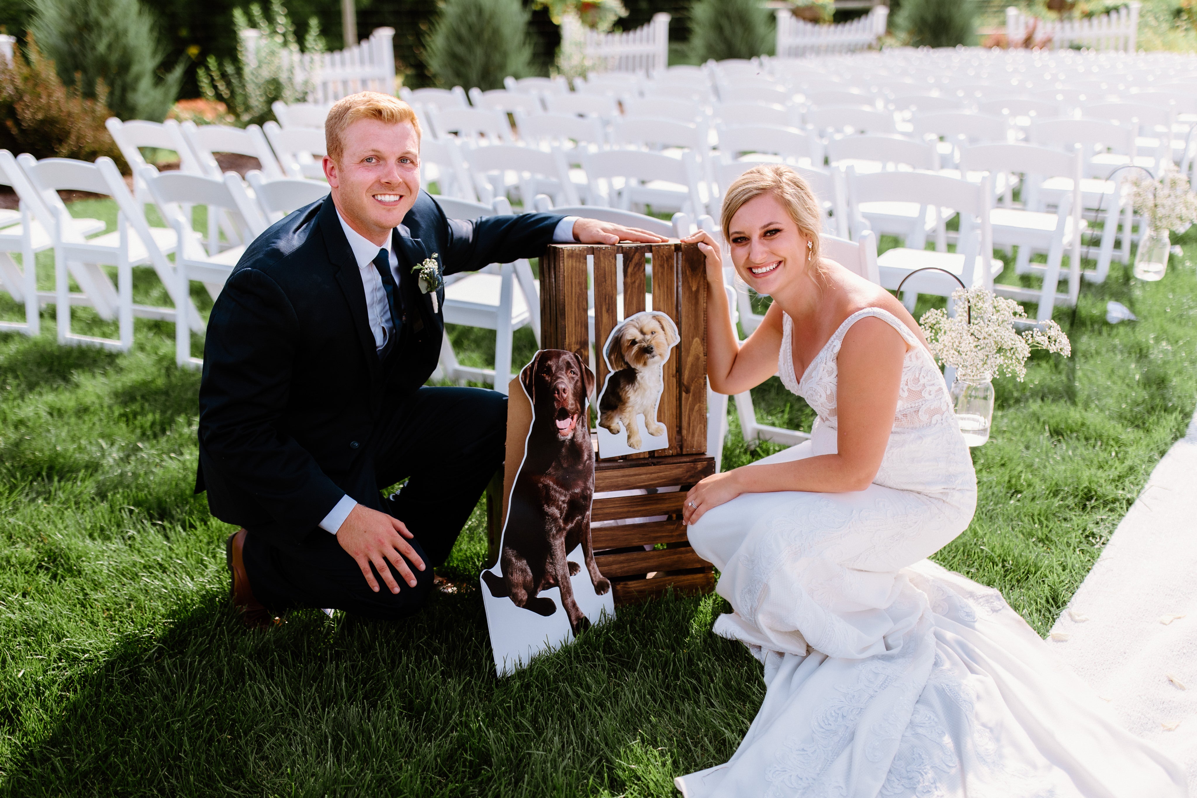 Melissa & her husband with her two dogs on their wedding day.