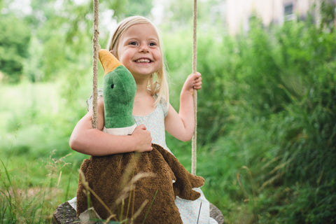 Girl with large senger drake on swing