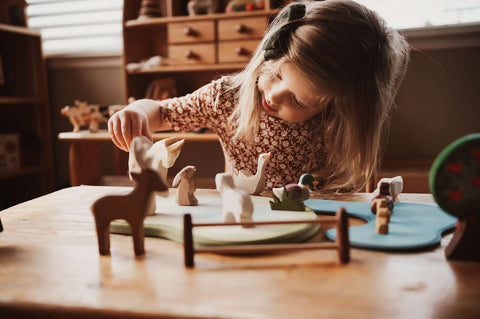 Girl playing with Ostheimer animals - Blue Otter Toys