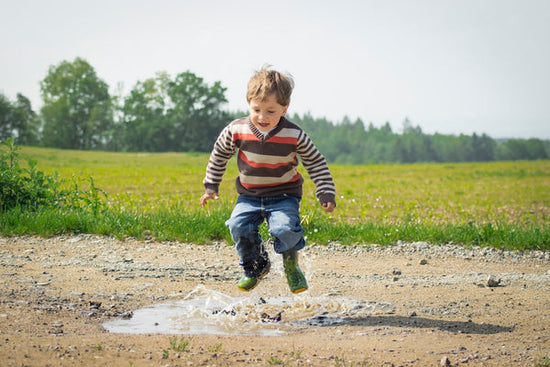 Child Playing in a Puddle