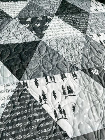 Close up photograph of a quilt.