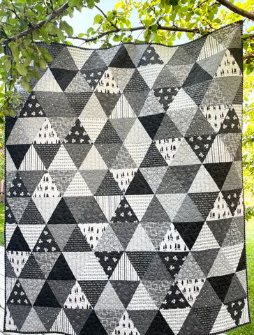 Photograph of quilt hanging in a tree
