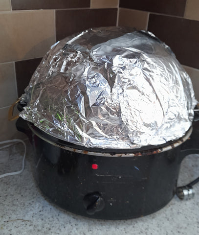 my slow cooker is switched on and I have a colander covered in tin foil to catch the steam