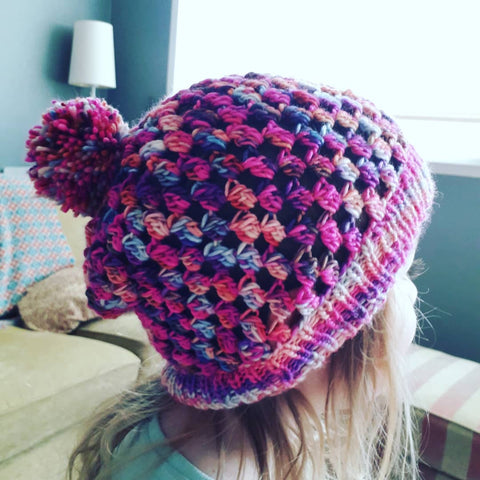 The jewel hat is a slich beanie with a knit brim and a crochet body. It's a hat that mixes crochet and knitting.