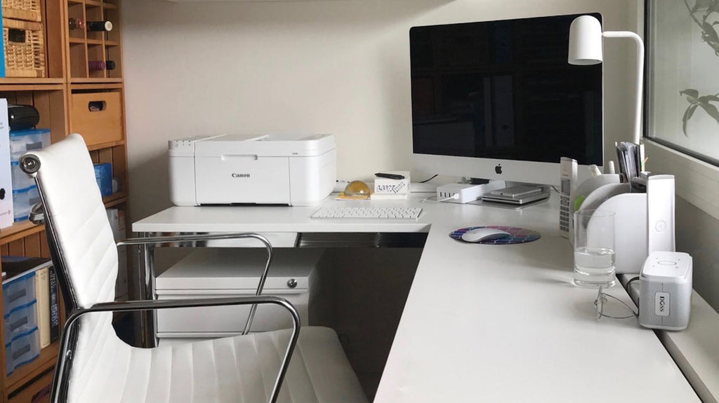 Minimalist home office with iMac and organized desk in Singapore