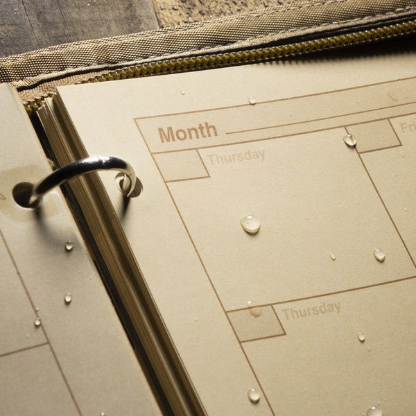 close up on monthly tab pages on Rite In The Rain waterproof calendar
