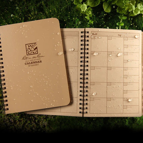 brown notebook with calendar printed inside