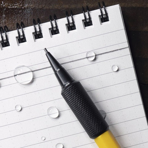 close up of mechanical pencil on lined notebook