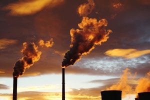 golden smoke from coal power plant during sunset