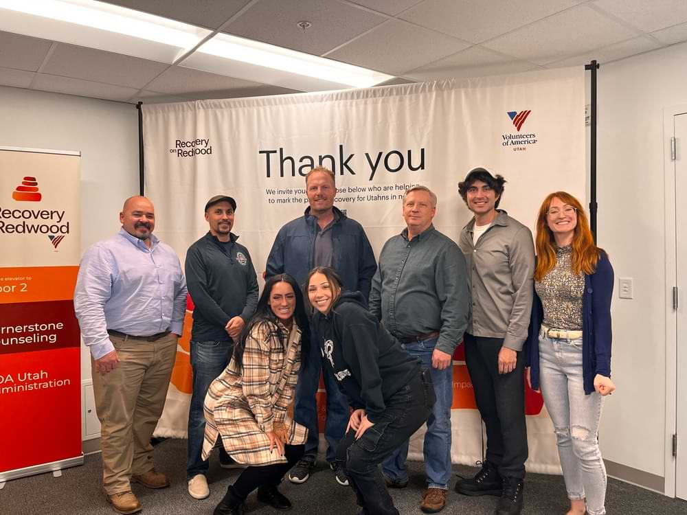 SeroVital employees standing in front of a thank you sign at a charity event