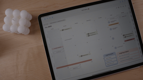 An iPad sitting on a desk next to a bubble candle. The Cyberry digital planner by KDigitalStudio is featured on the iPad screen.