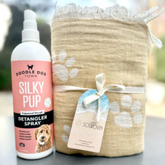 Silky Pup Detangler Spray Bottle next to Tan Paw Print Solwoven Towel