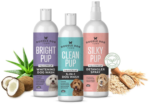 two bottles of dog shampoo and one bottle detangler spray surrounded by coconut, aloe and oatmeal ingredients