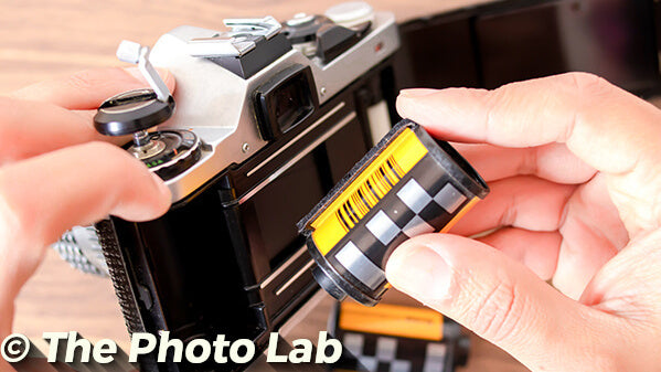 35mm film being inserted into a camera. Copyright The Photo Lab.