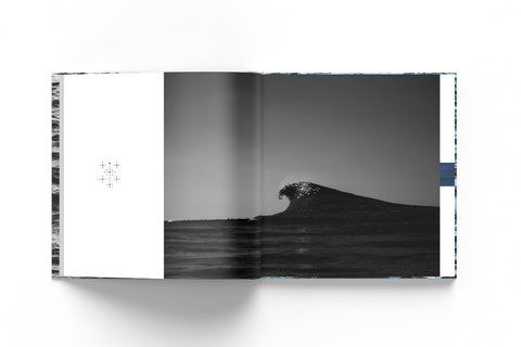 Mockup of an open book with the picture of a breaking wave in dark tones against a white background