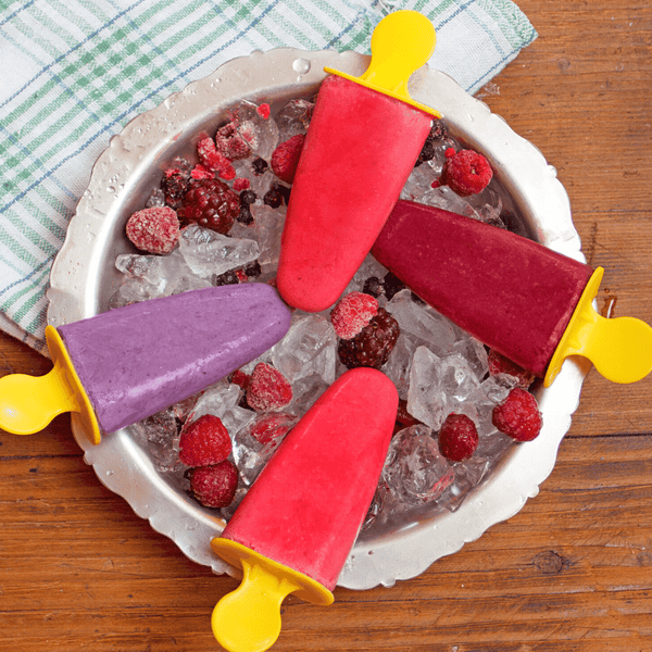 A variety of popsicles to beat the heat this summer. These popsicles are made with jam preserves including grapes, blackberries, and strawberries. Placed on top of an ice bucket to beat the heat this summer.