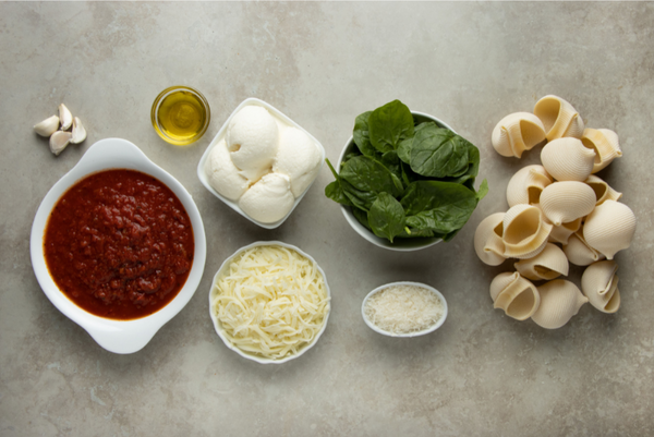 Ingredients for the baked lumaconi pasta or seashell casserole stuffed with cheese