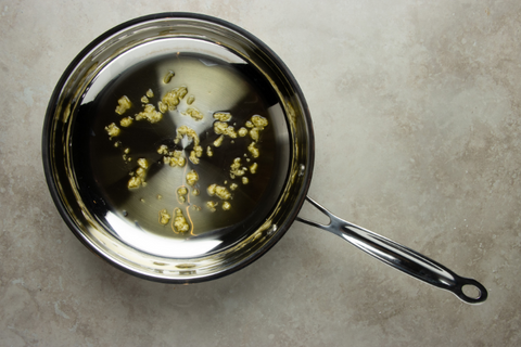 Add garlic to the pot and stir constantly until it has reached a golden brown color