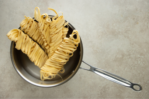Bring water to a boil and add tagliatelle pasta to cook until al dente