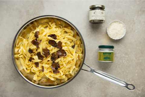 Add black truffle to the tagliatelle pasta and truffle salt