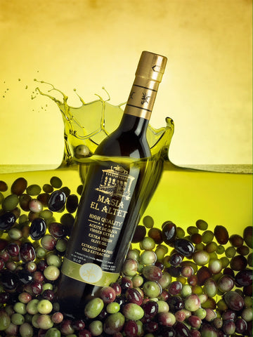 Extra Virgin Olive Oil Bottle Submerged in Pool of Olive Oil and Spanish Olives