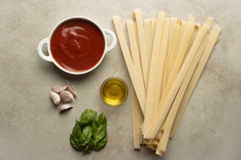Pappardelle pasta noodles, olive oil, basil, and garlic for the Tomato basil pappardelle pasta recipe by TerraMar Imports in the Cucina Tradizionale meal box.
