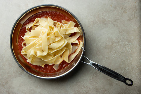 Mix the pappardelle pasta with the cherry red tomato sauce