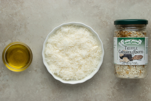 Ingredients to make a traditional truffle risotto: olive oil, parmigiano reggiano cheese, and truffle risotto mix