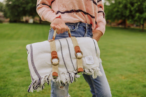 woman carrying picnic blanket