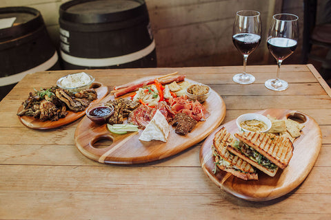 three different sized serving boards with a variety of appetizers