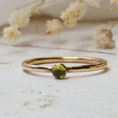 peridot birthstone for august - with gold ring