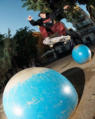 Skateboarder Doing An Ollie Riding Film Trucks